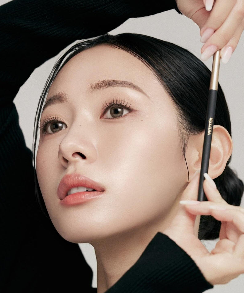 Woman using RULIDIA Easy Detail Brow pencil for precise eyebrow styling and shaping.