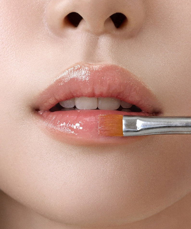 Close-up of lips with RULIDIA Shining Moment Caring Lip Balm 8g being applied, showcasing glossy finish and moisturizing effect.