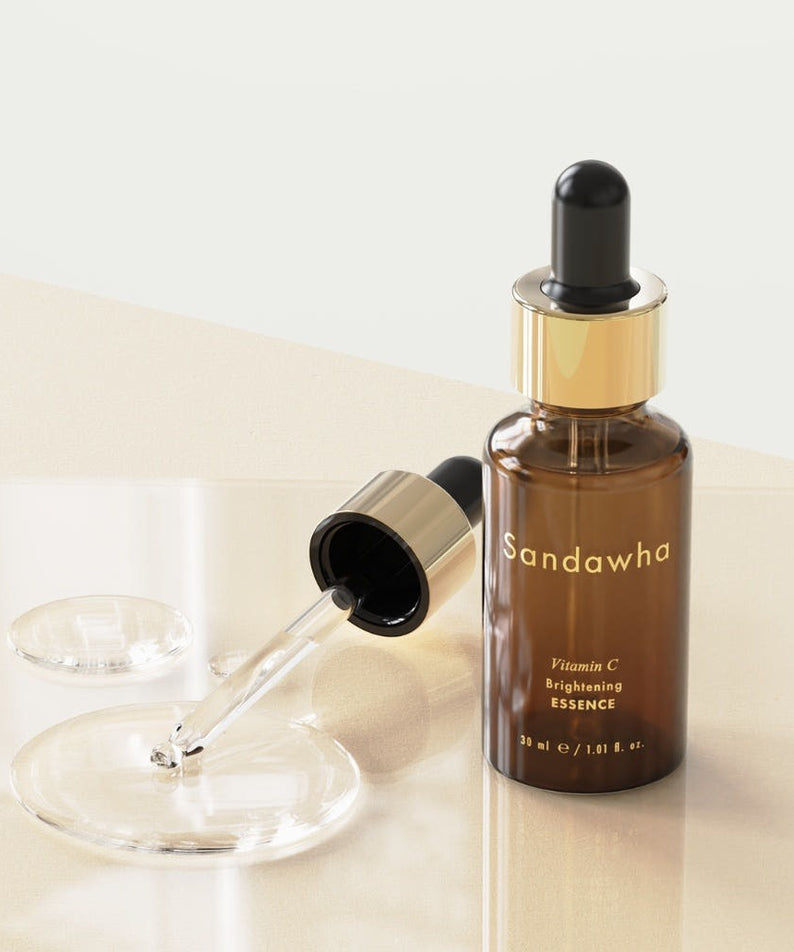 SANDAWHA Vitamin C Whitening Essence 30ml bottle with dropper on a glass surface.
