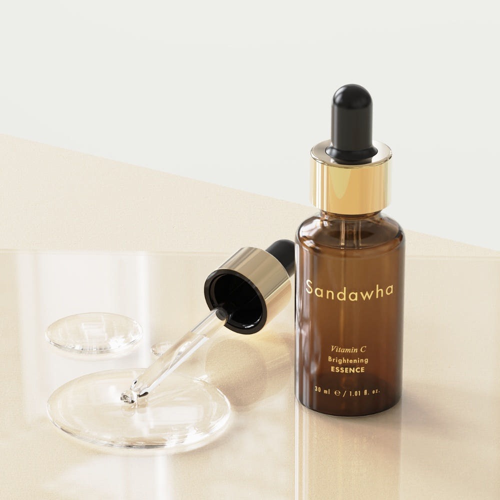 SANDAWHA Vitamin C Whitening Essence 30ml bottle with dropper on a glass surface.