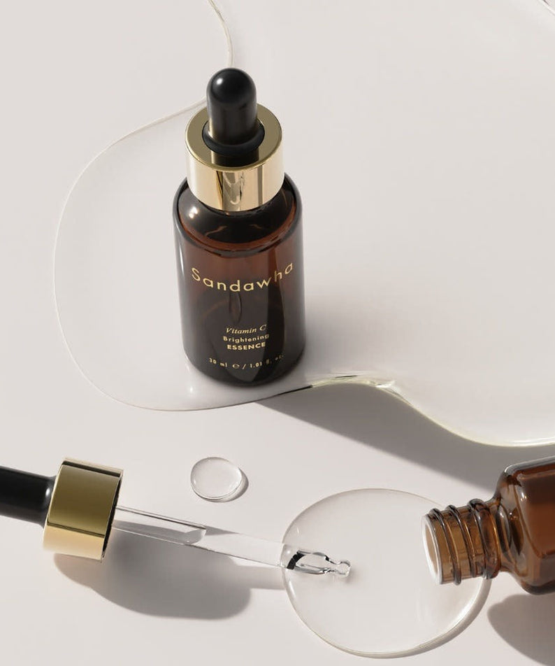 SANDAWHA Vitamin C Whitening Essence 30ml bottles and dropper with essence on a white background.