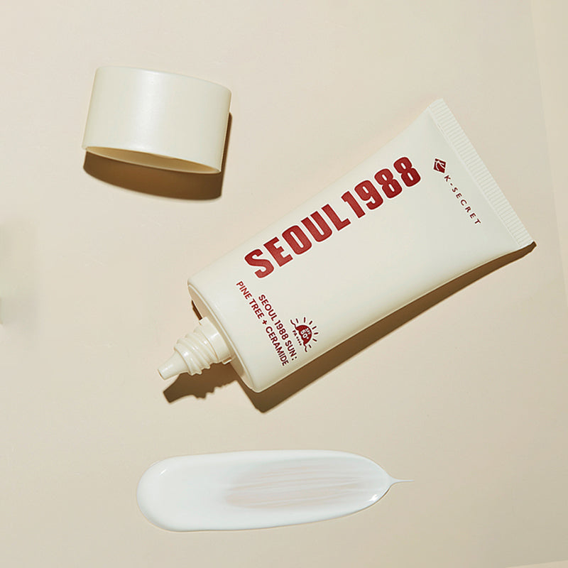 SEOUL 1988 Pine Sunscreen tube with cap and lotion smear on beige background