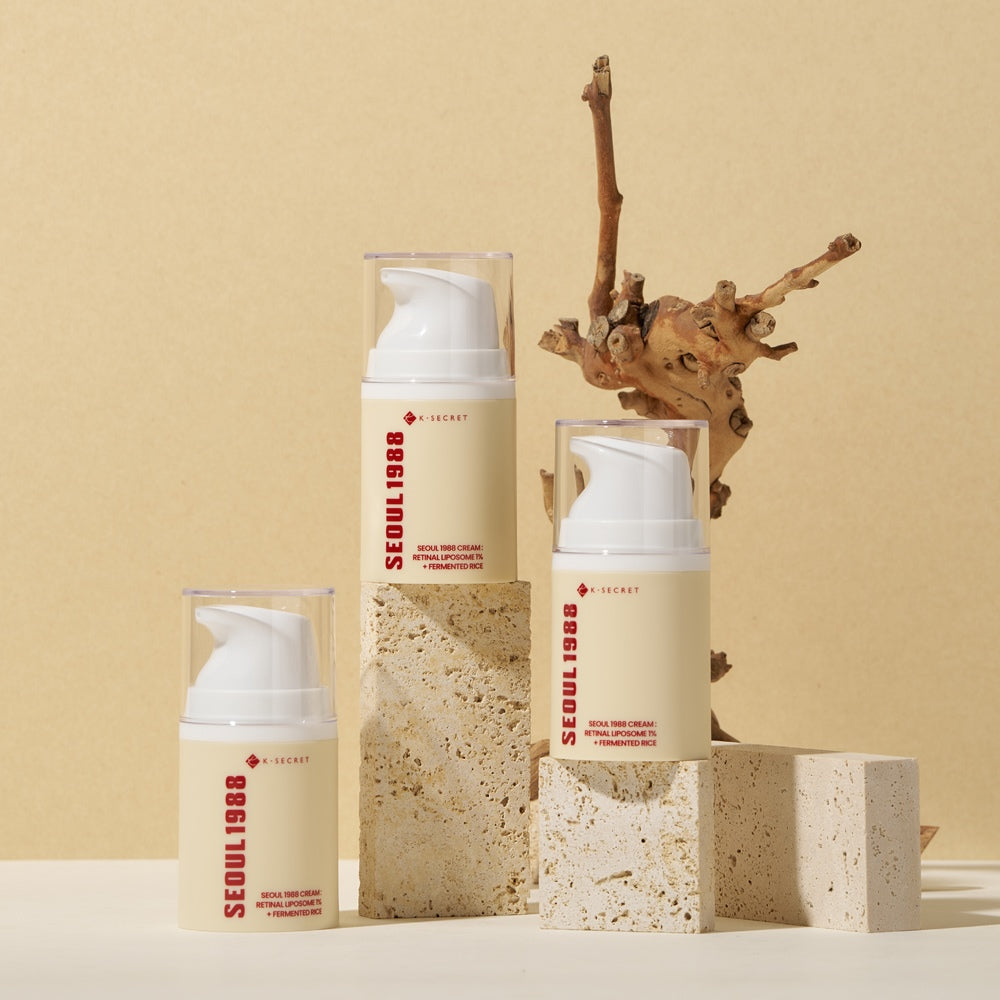 SEOUL 1988 Retinal Fermented Rice Cream bottles on stone blocks with natural wood backdrop