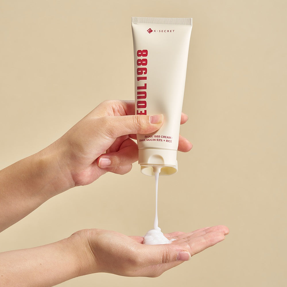 SEOUL 1988 Snail 93 Cream being applied from tube onto hand against neutral background