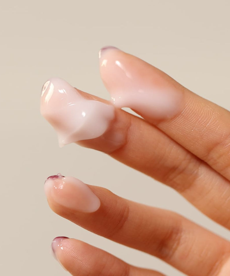 Person applying SHAISHAISHAI [1+] Aloe PDRN Cooling Repair Cream 50ml on fingertips