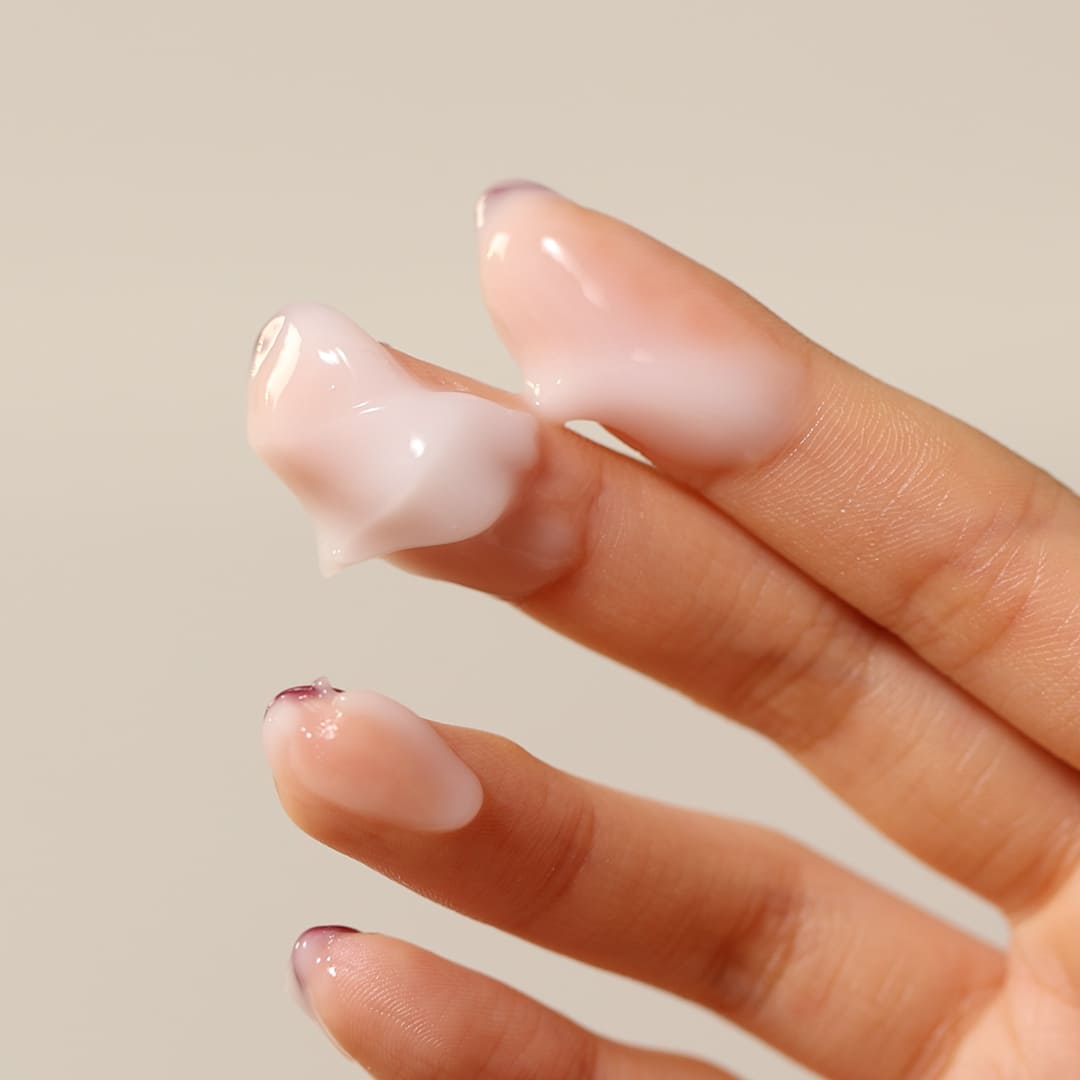 Person applying SHAISHAISHAI [1+] Aloe PDRN Cooling Repair Cream 50ml on fingertips