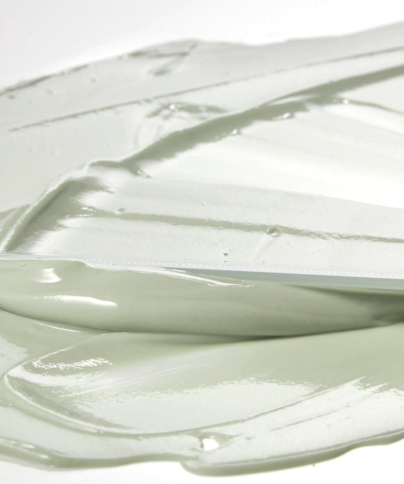 Texture of SHAISHAISHAI [1+1]Aloe PDRN Cooling Mud Mask 100ml cream spread with a spatula, showing smooth and creamy consistency.