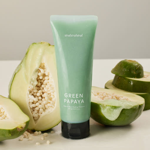 SHAISHAISHAI Green Papaya Body & Face Peeling Cleanser 150ml tube with fresh papaya slices in the background.