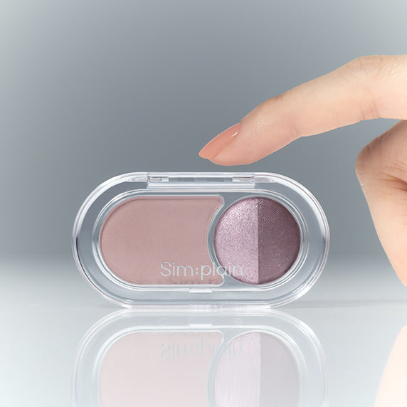 SIM;PLAIN Gleam On Eyes eyeshadow compact with finger pointing at shimmer shades