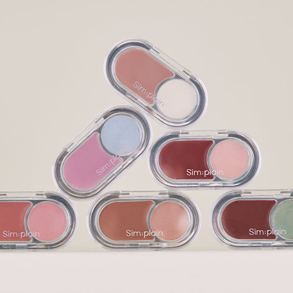SIM;PLAIN Glim on the night makeup palettes in various colors stacked on a neutral background.