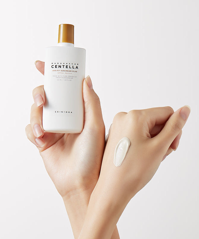 Close-up of hands holding SKIN1004 Madagascar Centella Air-fit Sunscreen Plus 50ml showing texture.