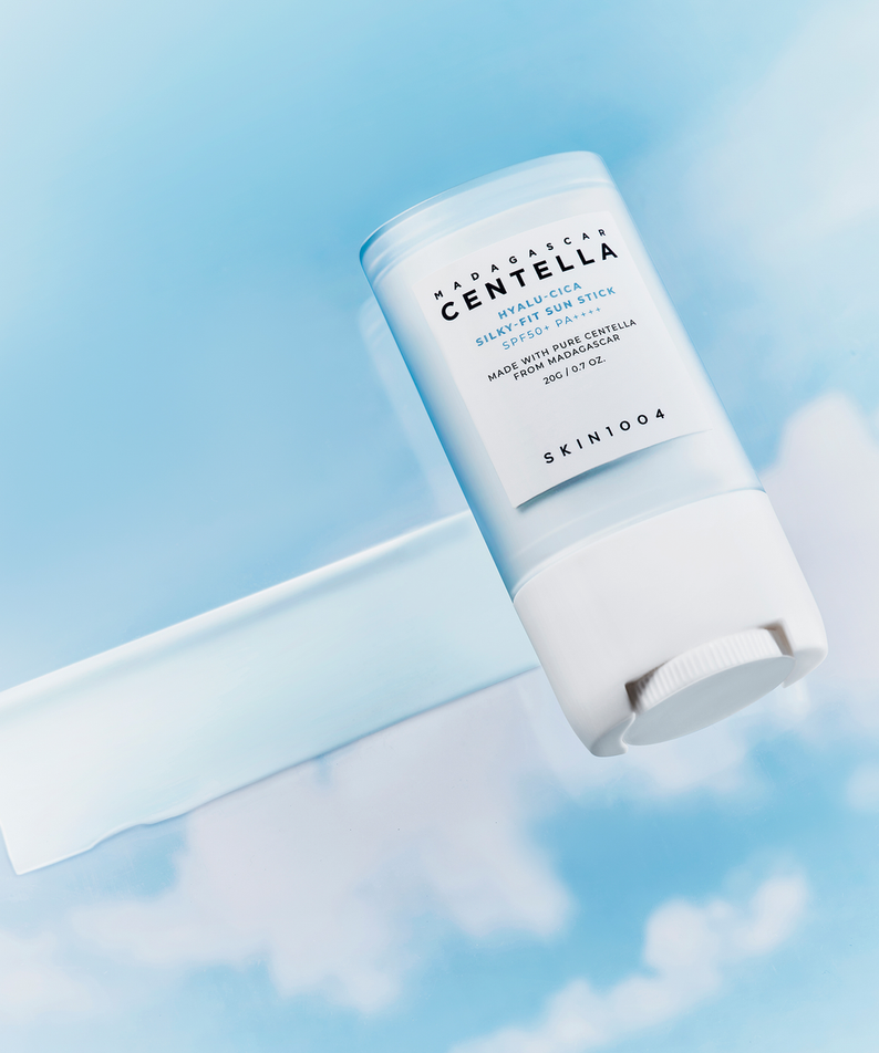 SKIN1004 Madagascar Centella Hyalu-Cica Silky Fit Sun Stick 20g on a blue sky background.