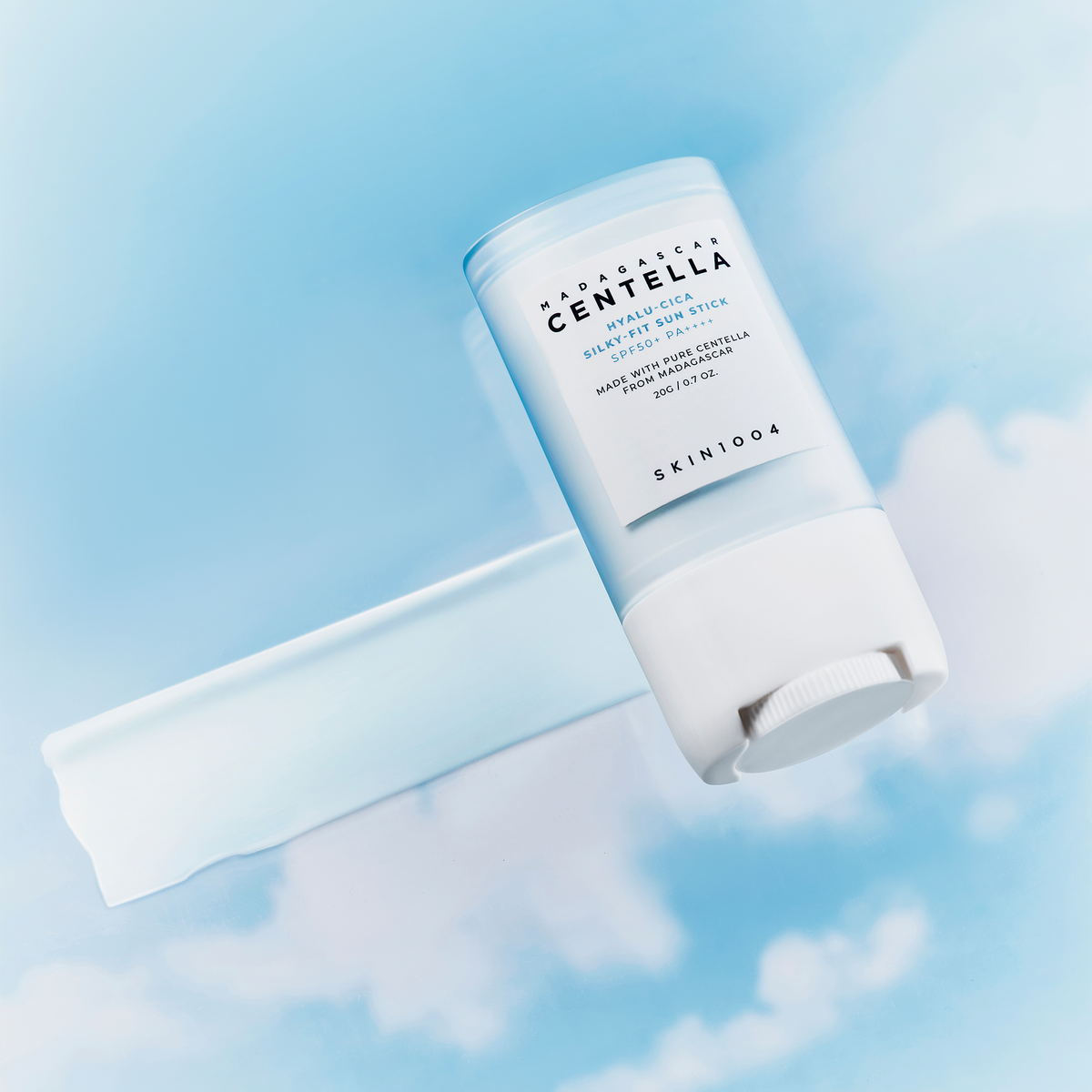 SKIN1004 Madagascar Centella Hyalu-Cica Silky Fit Sun Stick 20g on a blue sky background.