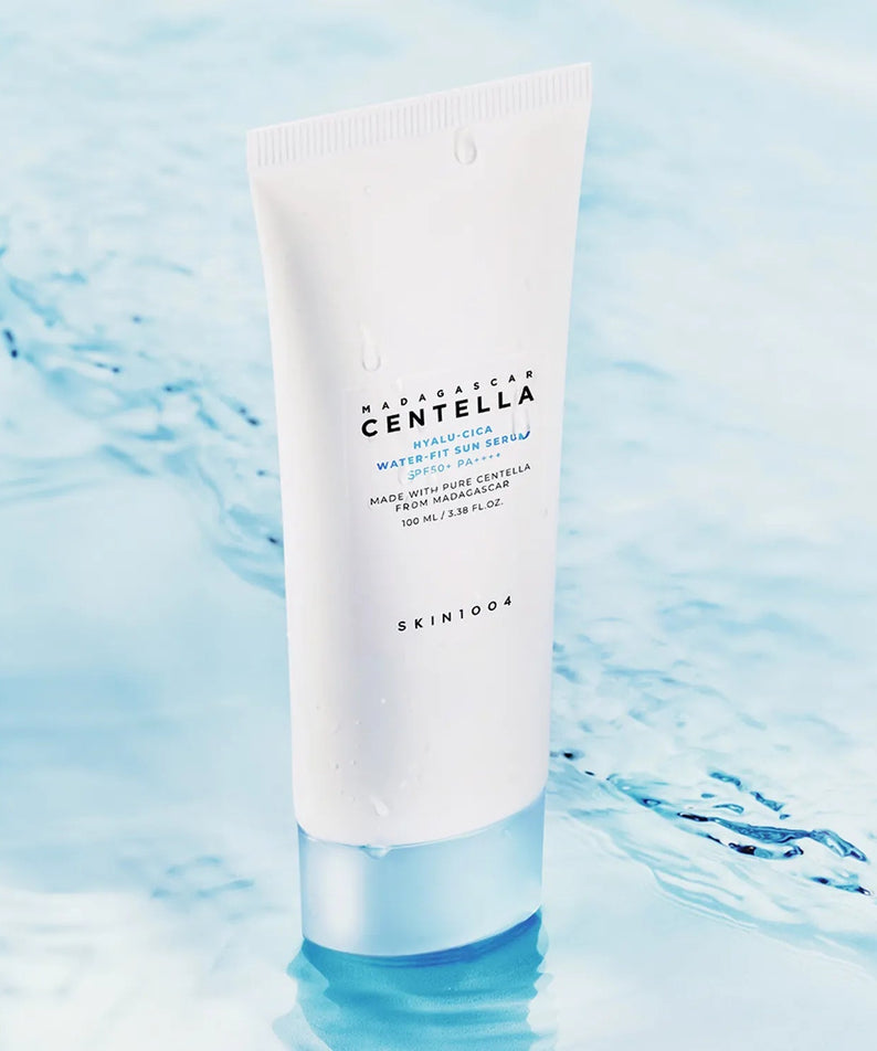 SKIN1004 Madagascar Centella Hyaluronic Acid Water-Fit Sun Serum 100ml tube placed on a serene water background