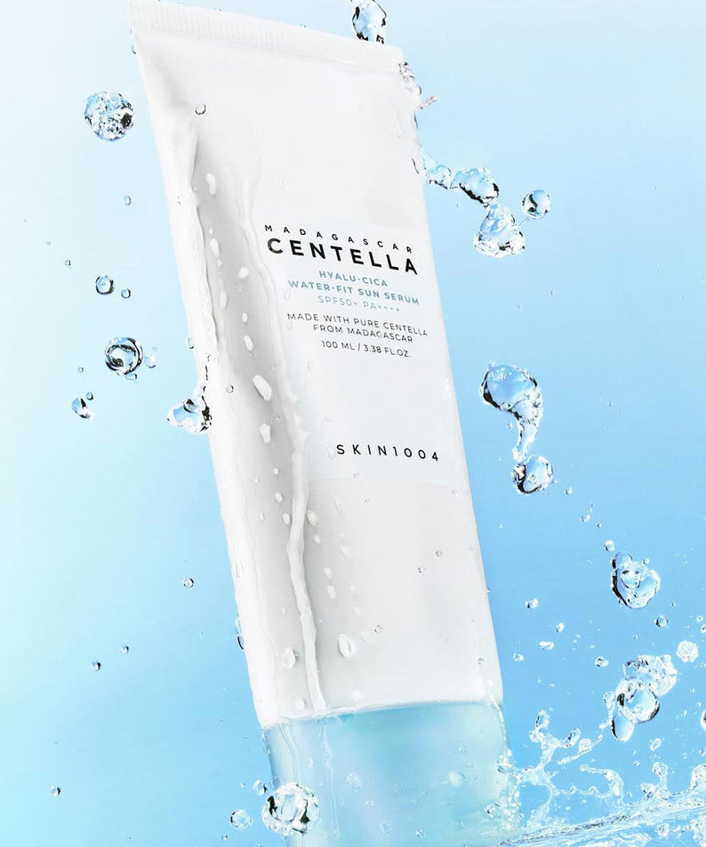 SKIN1004 Madagascar Centella Hyaluronic Acid Water-Fit Sun Serum 100ml with water droplets on blue background
