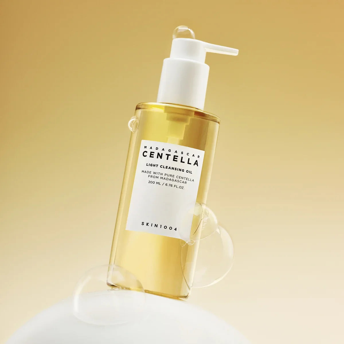Bottle of SKIN1004 Madagascar Centella Light Cleansing Oil 200ml with bubbles on a neutral background