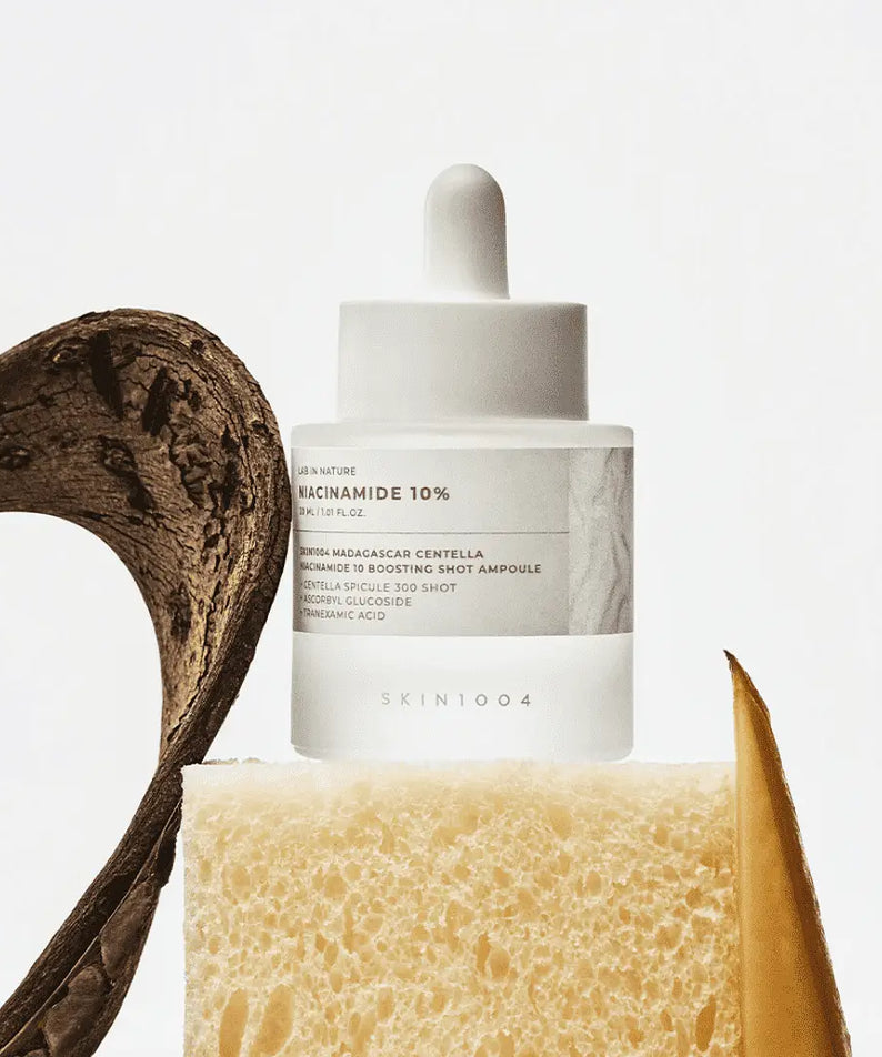 SKIN1004 Madagascar Centella Niacinamide 10 Boosting Shot Ampoule 30ml on display with natural elements