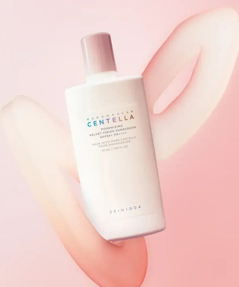 SKIN1004 Madagascar Centella Poreizing Velvet Finish Sunscreen 50ml bottle on a pink background