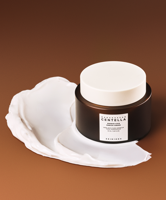 SKIN1004 Madagascar Centella Probio-cica Enrich Cream 50ml on a brown background with cream texture
