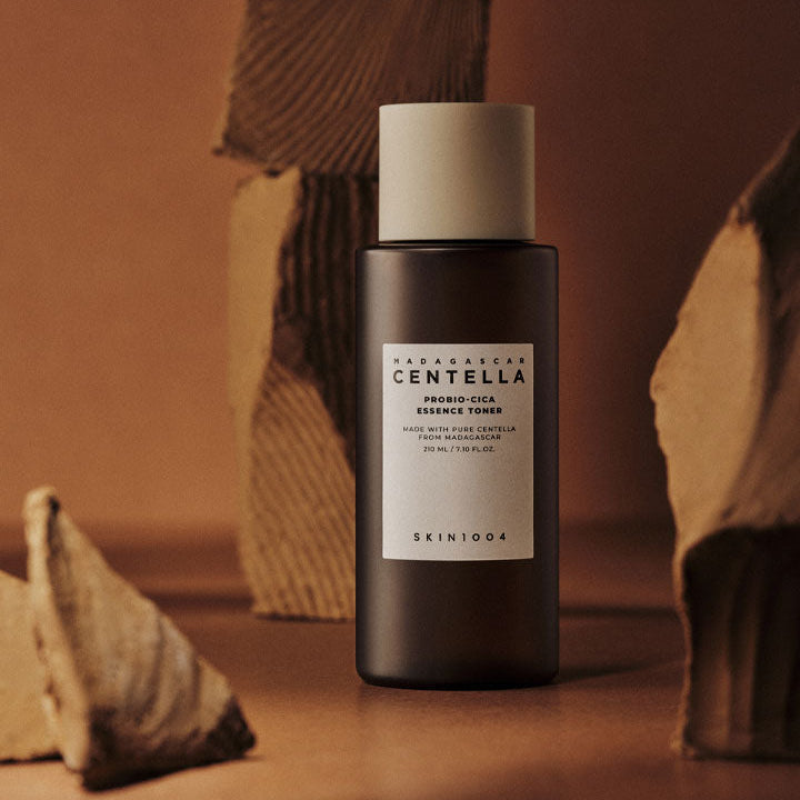 SKIN1004 Madagascar Centella Probio-cica Essence Toner 210ml bottle on a brown decorative background