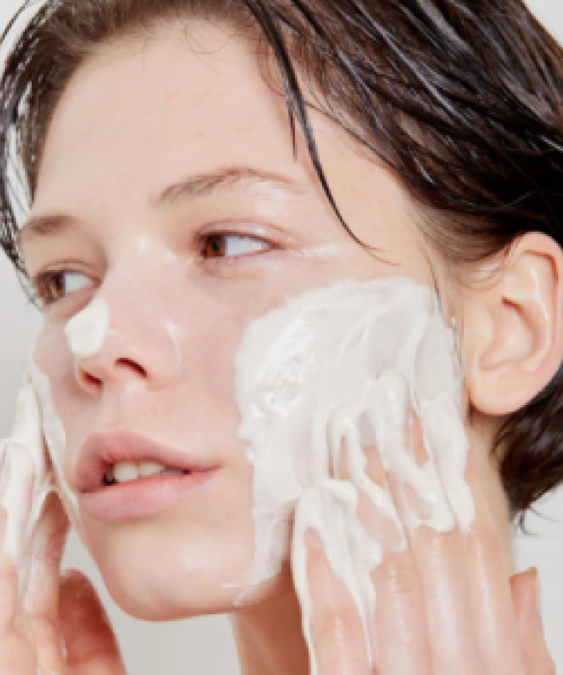 Woman applying SKIN1004 Madagascar Centella Tea-trica BHA Foam 125ml on face