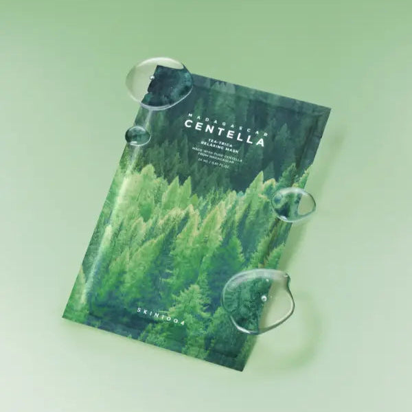 SKIN1004 Madagascar Centella Tea-trica Relaxing Mask 24ml [5 sheets] displayed against a green background with water droplets.
