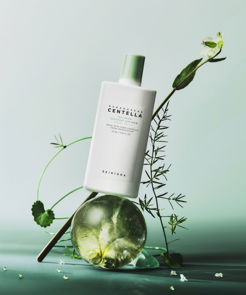 SKIN1004 Madagascar Centella Tea-trica Soothing Sun Milk 50ml bottle with natural elements displayed elegantly