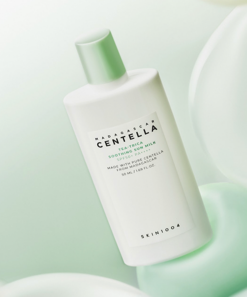 Image of SKIN1004 Madagascar Centella Tea-trica Soothing Sun Milk 50ml bottle with soft green background.