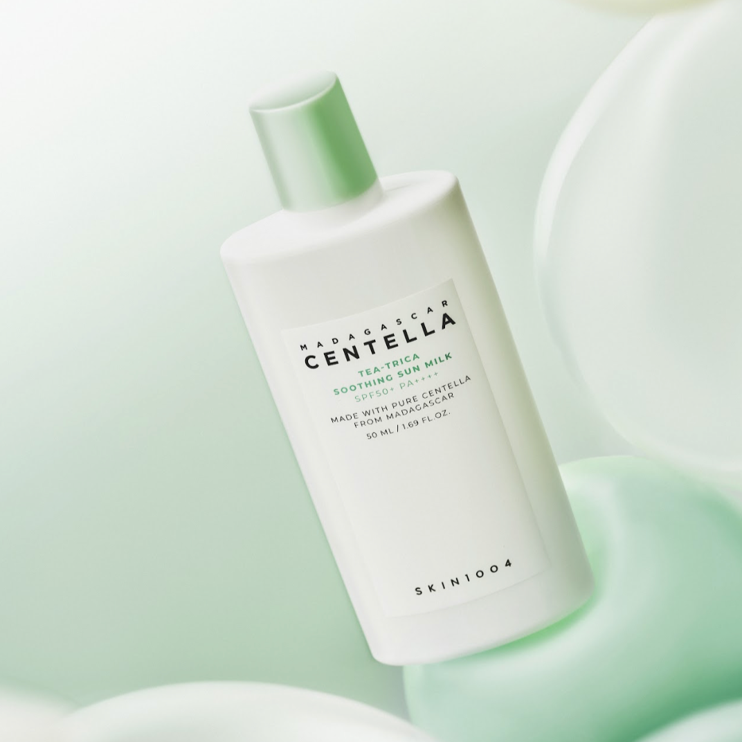 Image of SKIN1004 Madagascar Centella Tea-trica Soothing Sun Milk 50ml bottle with soft green background.