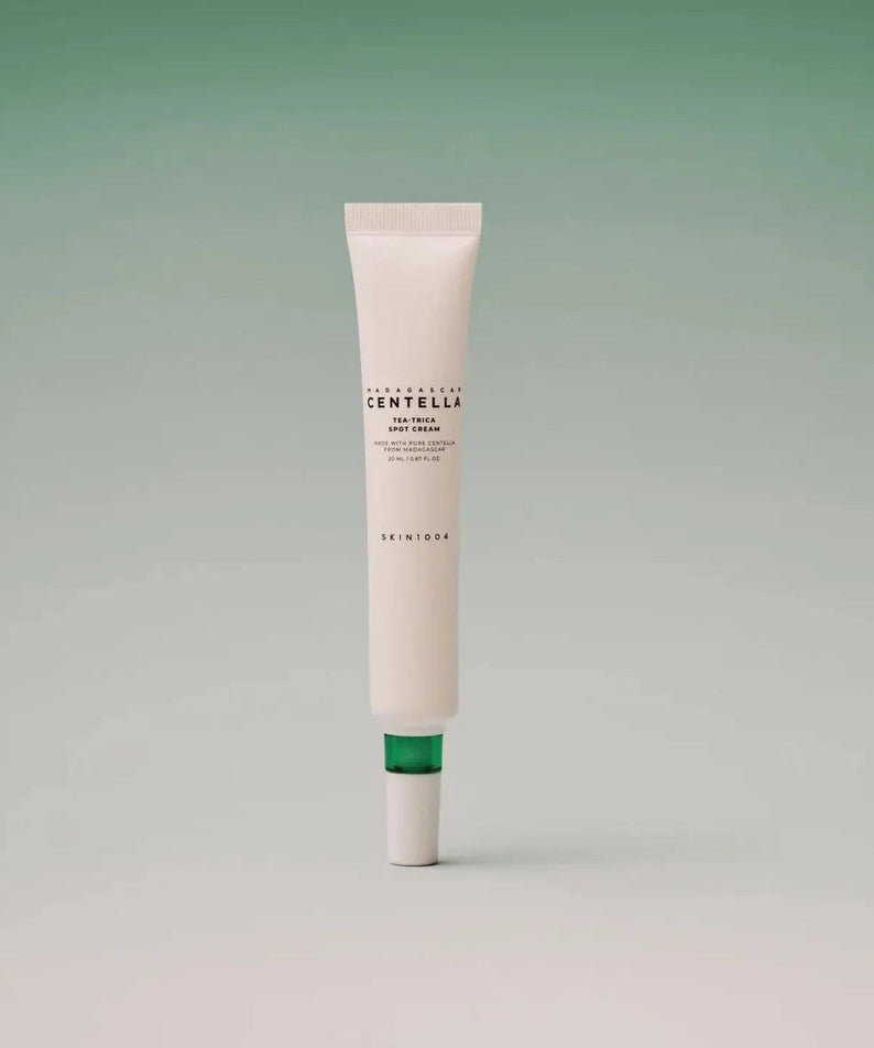 SKIN1004 Madagascar Centella Tea-trica Spot Cream 20ml tube on a green gradient background