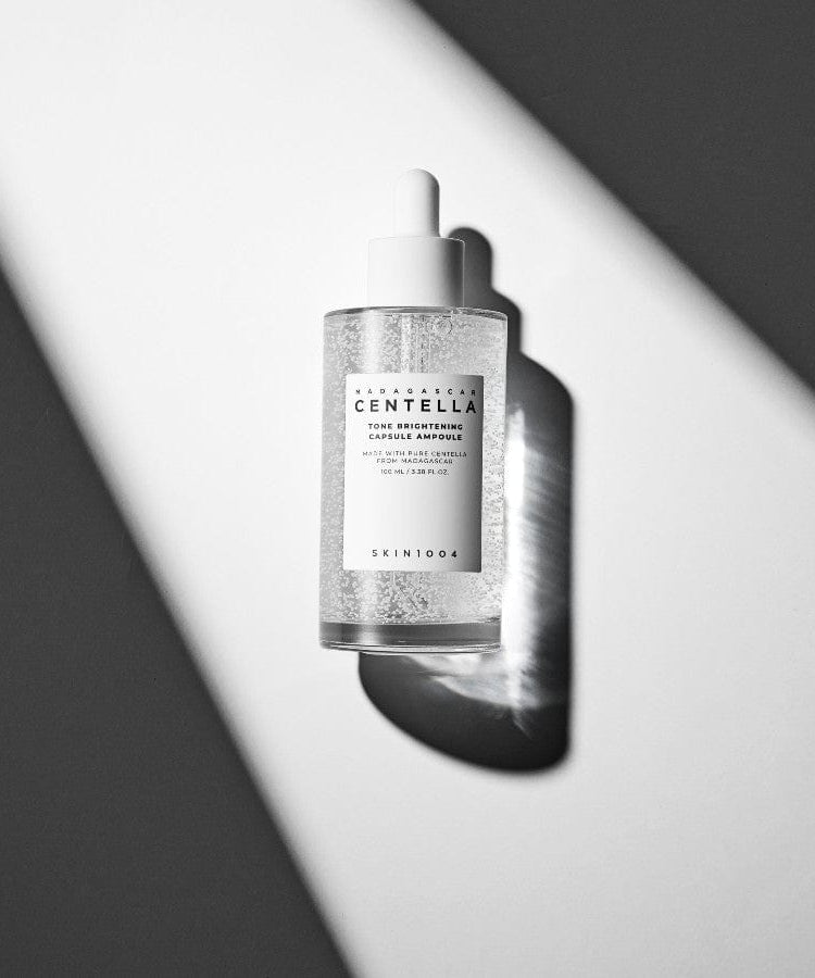 SKIN1004 Madagascar Centella Tone Brightening Capsule Ampoule 100ml bottle on a white and gray background.