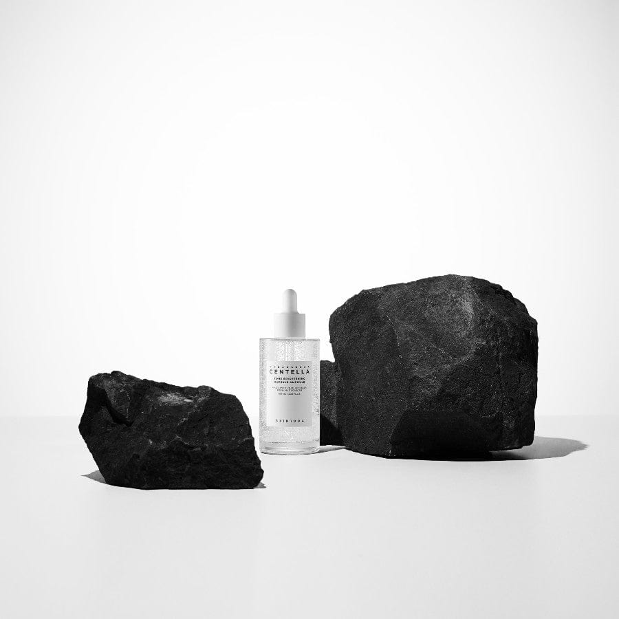 SKIN1004 Madagascar Centella Tone Brightening Capsule Ampoule 100ml with black rocks background