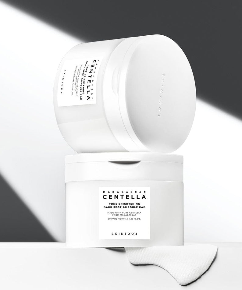 SKIN1004 Madagascar Centella Tone Brightening Dark Spot Ampoule Pads (60 sheets) in minimalist packaging displayed on a light background.