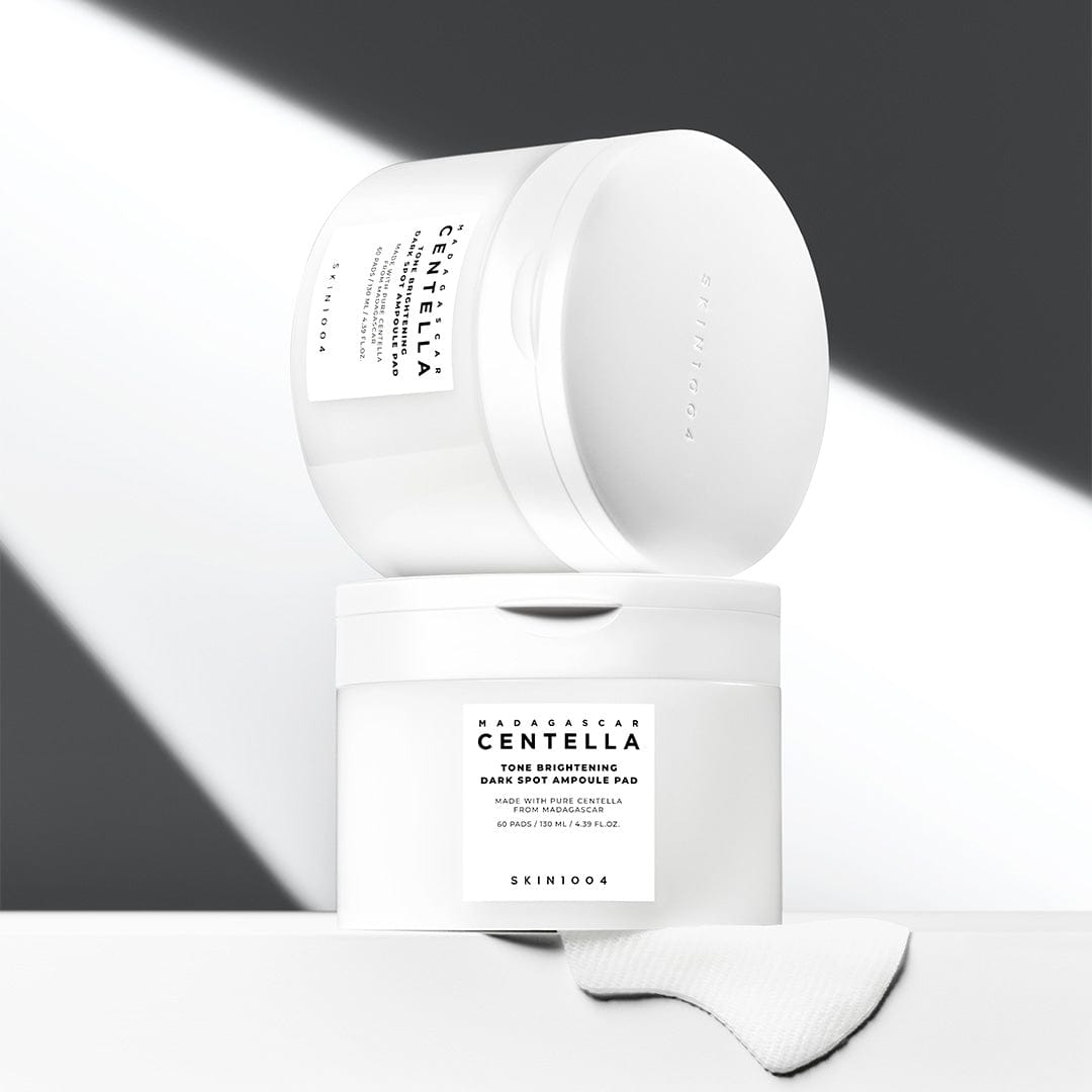SKIN1004 Madagascar Centella Tone Brightening Dark Spot Ampoule Pads (60 sheets) in minimalist packaging displayed on a light background.