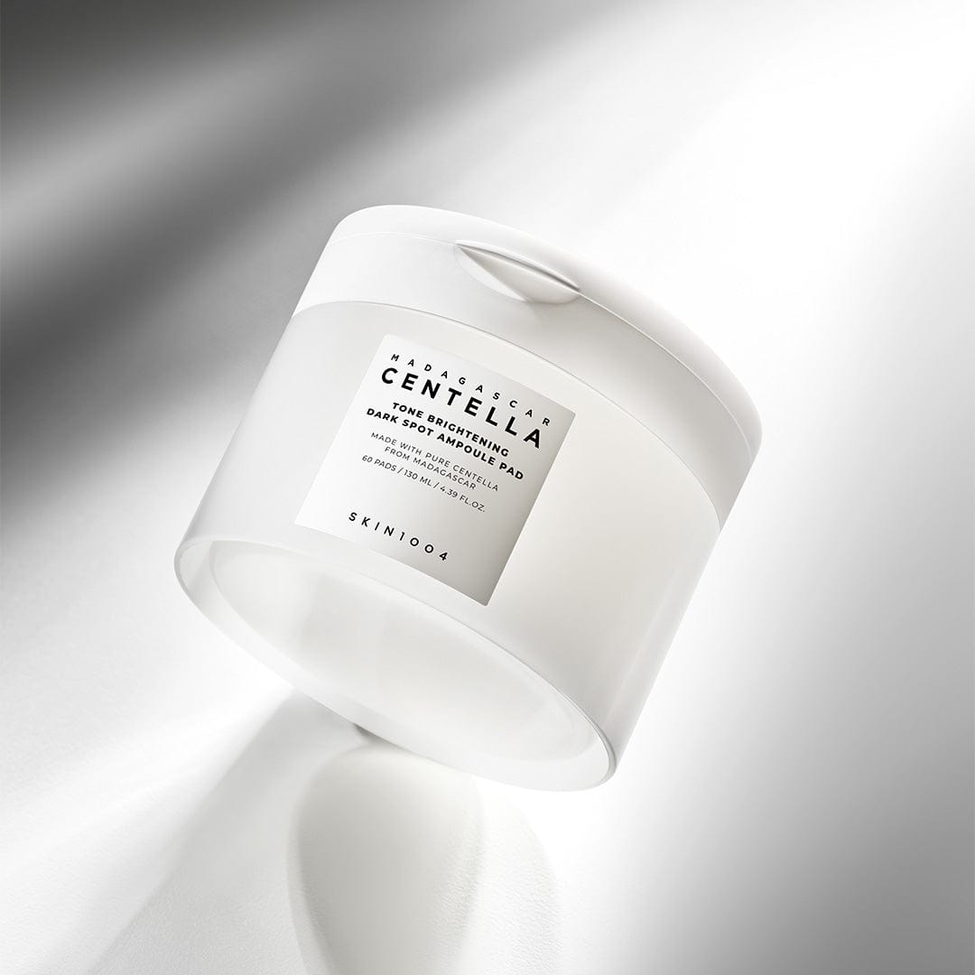 SKIN1004 Madagascar Centella Tone Brightening Dark Spot Ampoule Pads (60 sheets) in a sleek white container.