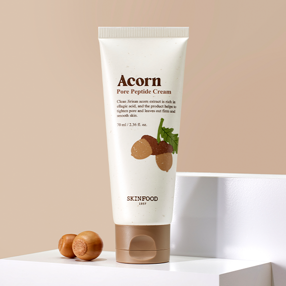 SKINFOOD Acorn Pore Peptide Cream 70ml tube on display with acorn illustration on the packaging.