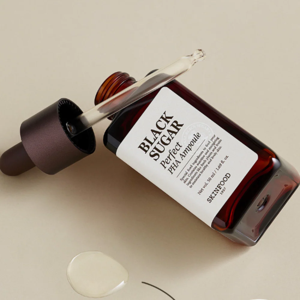 SKINFOOD Black Sugar Perfect PHA Ampoule 50ml in opened bottle with dropper and product on beige background