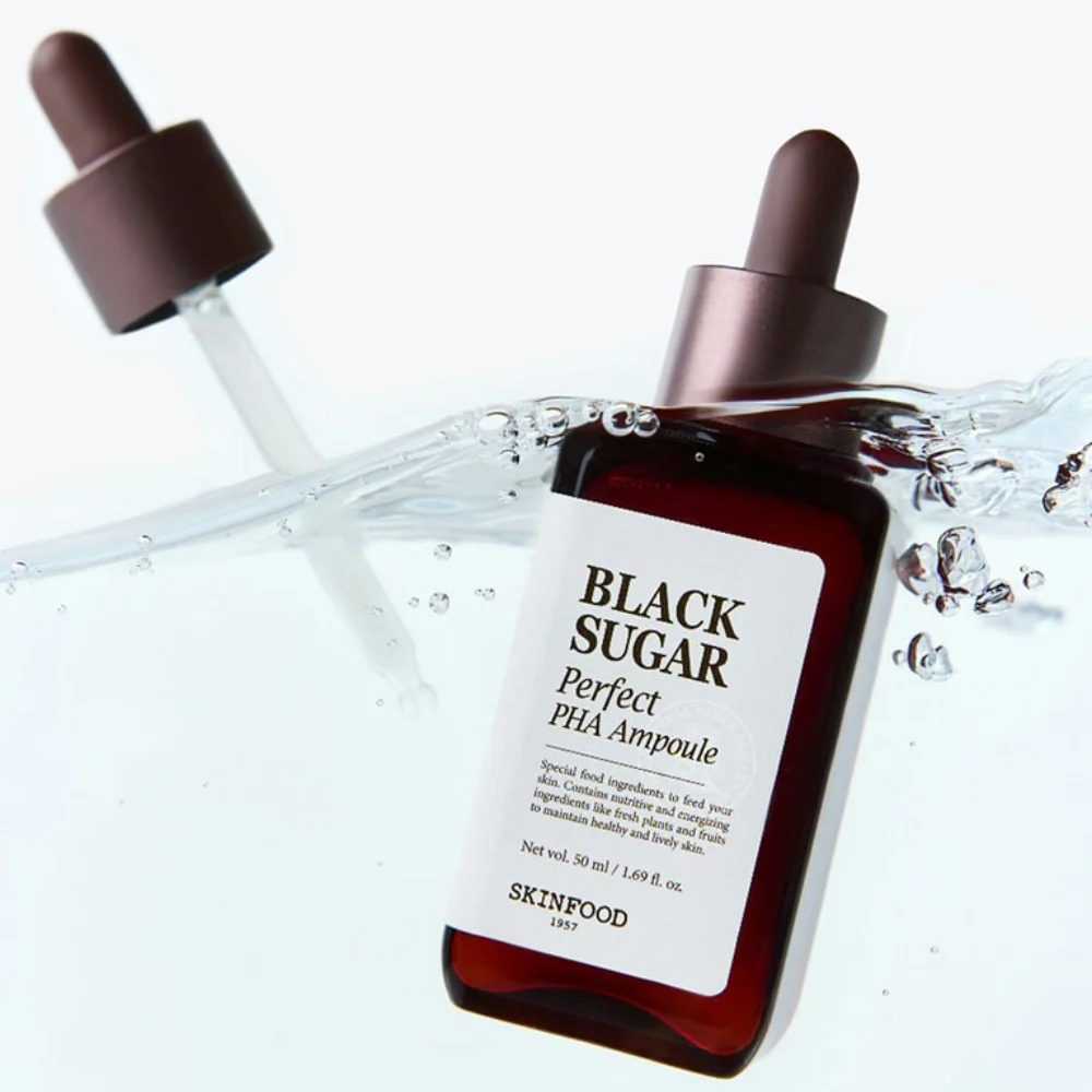 SKINFOOD Black Sugar Perfect PHA Ampoule 50ml submerged in water with dropper lid, highlighting skincare product packaging and design.