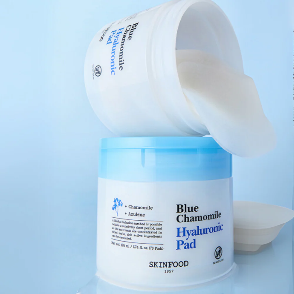 Open container of SKINFOOD Blue Chamomile Hyaluronic Gel Pads 70 Sheets with pads visible, enhancing skincare routine.