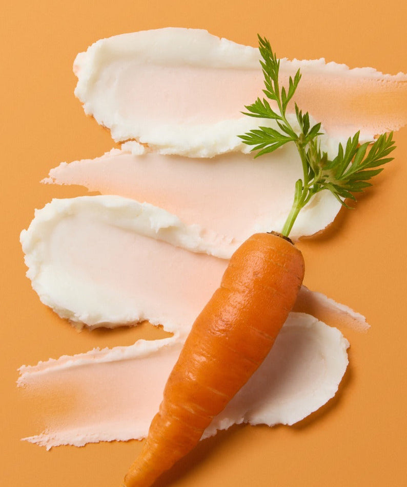 SKINFOOD Carrot Airy Soft Sun Stick 18.5g moisturizing cream with a fresh carrot on peach background