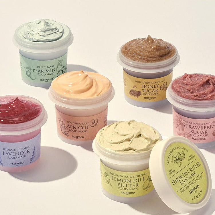 Variety of SKINFOOD Food Mask 120g jars in different flavors arranged in a group.