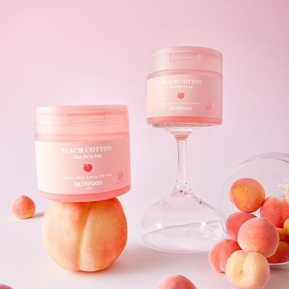 SKINFOOD [NEW] Peachy Zinc PCA Pad 70 sheets displayed with peaches and elegant glassware