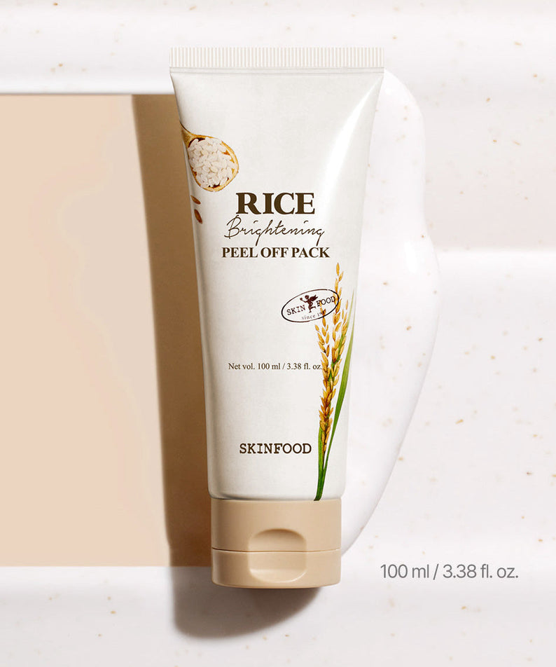 Image of SKINFOOD [NEW] Rice Brightening Peel-Off Pack 100ml with cream smear on white surface.