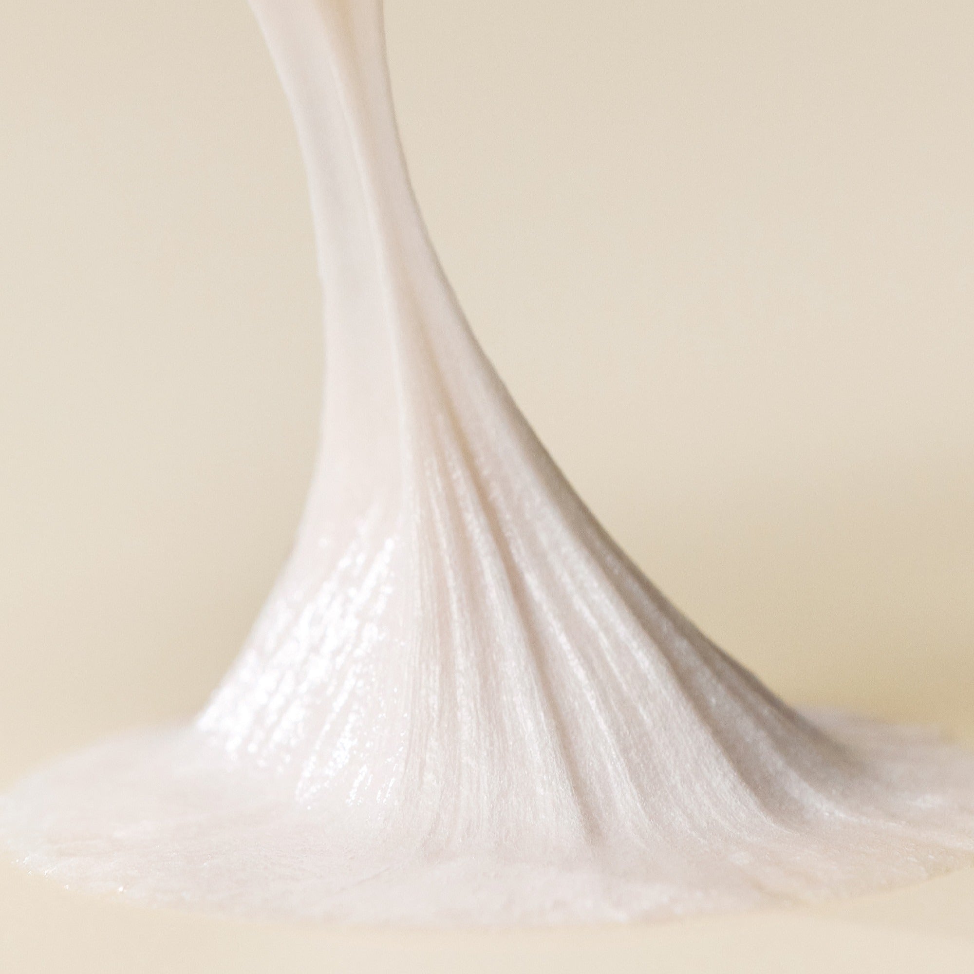 Texture of SOME BY MI Lactosoy Enzyme Deep Cleansing Foam 100ml being poured, highlighting its creamy consistency.