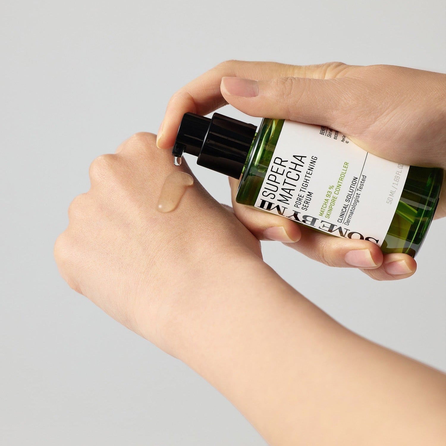 Applying SOME BY MI Super Matcha Pore Tightening Serum 50ml on hand