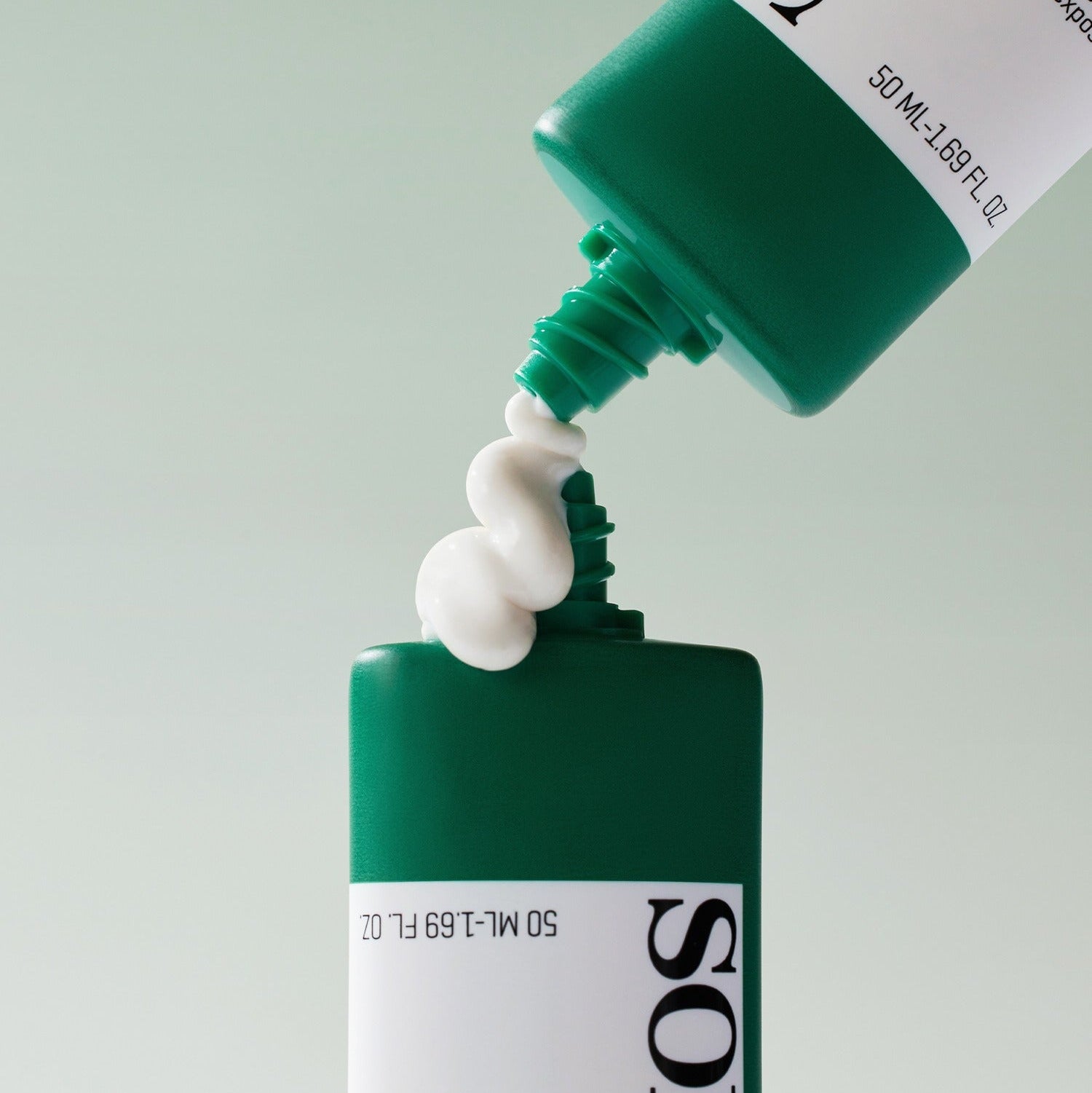 SOME BY MI Truecica Aqua Calming Sun Cream 50ml being poured from green tube for skincare protection