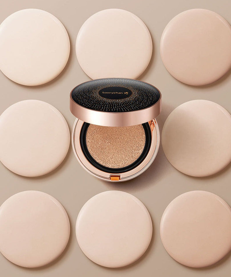 SOORYEHAN Beautiful Black Ginseng Cushion Project 15g surrounded by beige makeup pads, showcasing the elegant packaging and cushion texture.