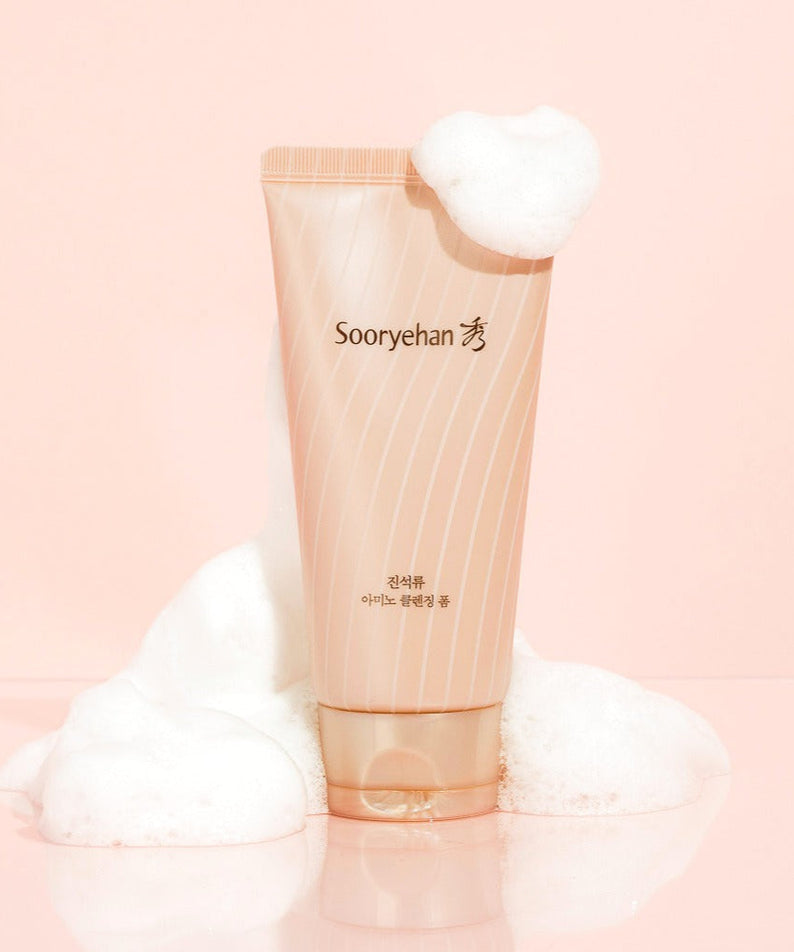 SOORYEHAN Jinseokryu Amino Cleansing Foam 160ml product image with foam on a pink background.