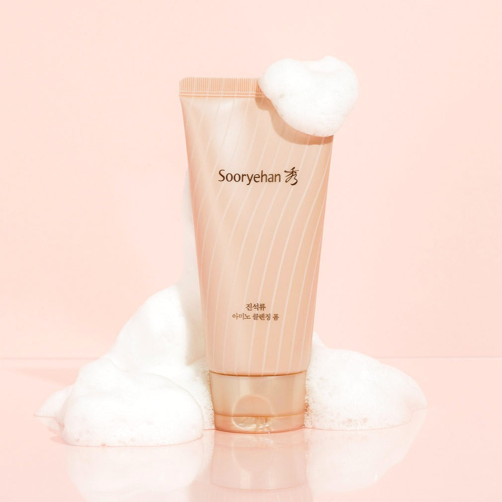 SOORYEHAN Jinseokryu Amino Cleansing Foam 160ml product image with foam on a pink background.