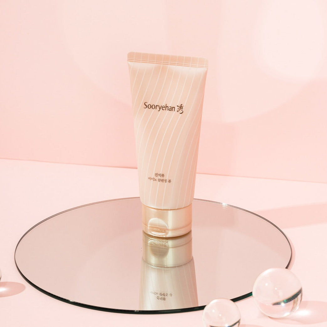 SOORYEHAN Jinseokryu Amino Cleansing Foam 160ml product displayed on a mirror with a soft pink background.